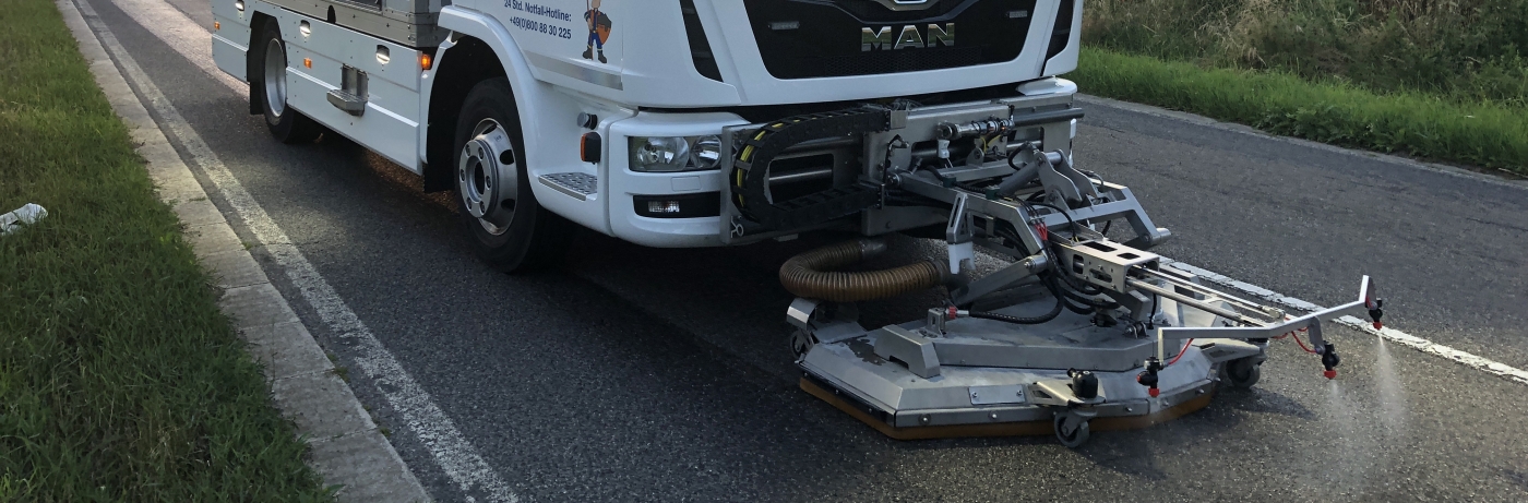 reinigungswagen-eures-ueber-uns Eures • Reinigungsfahrzeug auf Straße mit Kehrausrüstung im Einsatz.